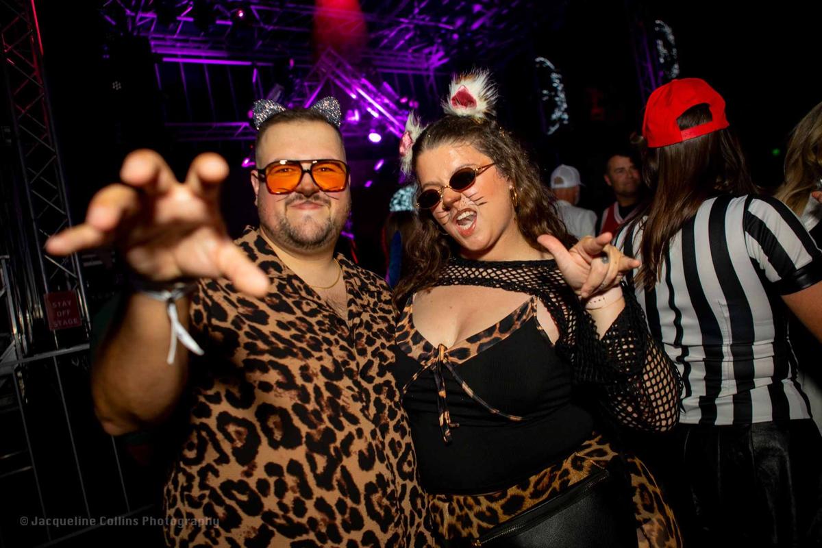 Guests in colorful costumes at Coloween, the Denver Halloween Party