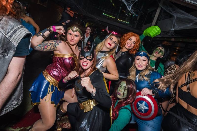 Superhero squad flexes with shield and giant green fist at Coloween's Halloween costume party