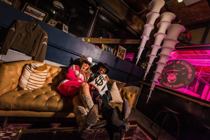 Rhinestone cowgirl and cowboy with a money bag in the lounge