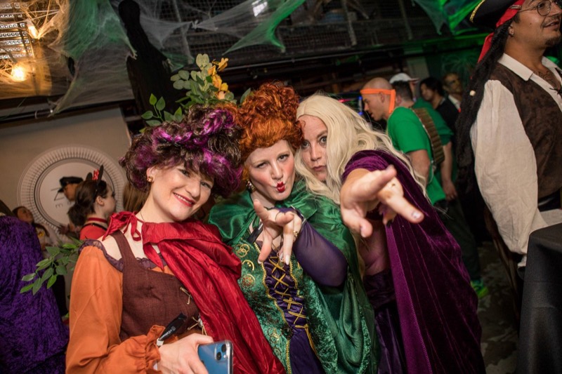 Three witch sisters in full wigs pointing straight at the camera at Coloween 2021 in Colorado