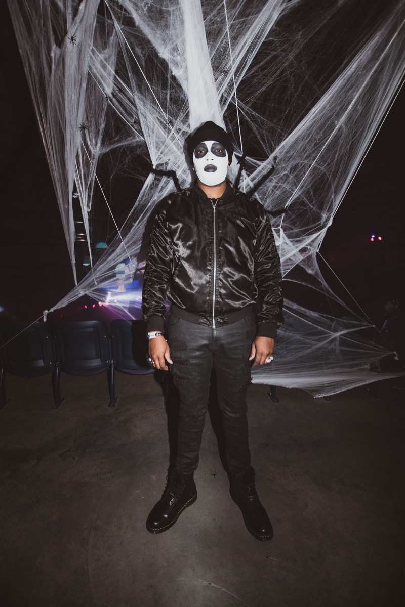 Skeletal face paint framed by a wall of spiderwebs at the Coloween costume contest in Denver
