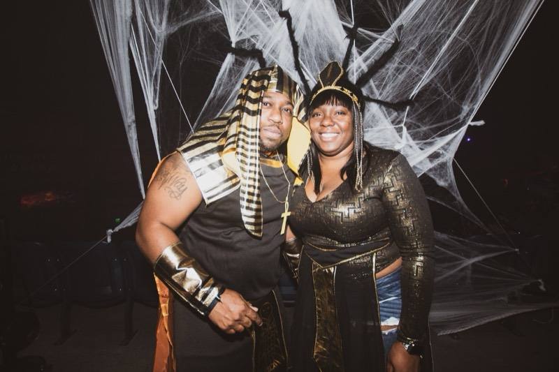 Pharaoh and Cleopatra pose arm in arm before the spiderweb wall at the Coloween costume contest in Denver