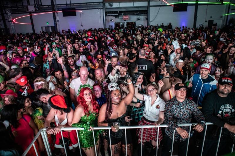 Poison Ivy and a skull masquerade lead a packed dance floor at the adults-only Coloween Halloween event