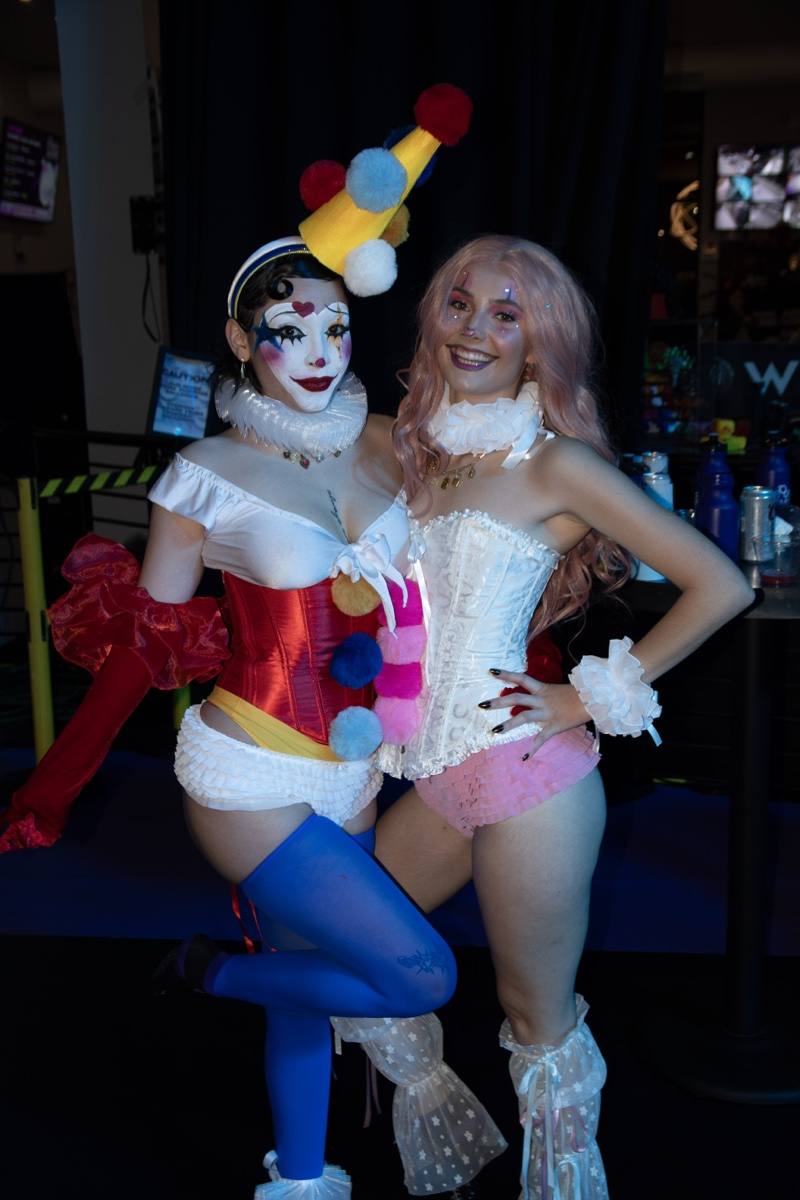 Burlesque clowns in full paint hold their pose for a portrait
