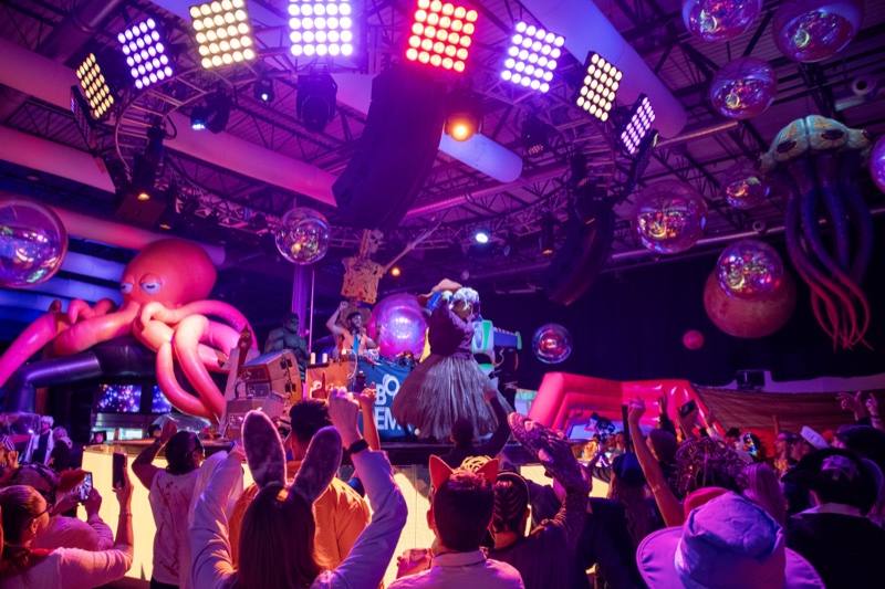Costume contest in full swing, light grids up and hands raised at the adults-only Coloween Halloween event