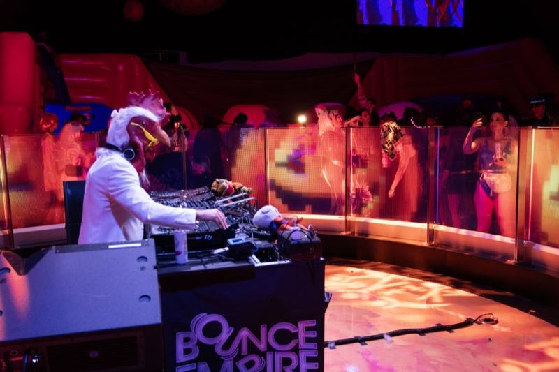 A chicken-headed DJ in a white suit runs the booth at Coloween — Denver Halloween nightlife
